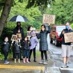 Though not all community members joined in the march, many neighbors stood near their houses to show their support of the protest. Blake Peterson/staff photo