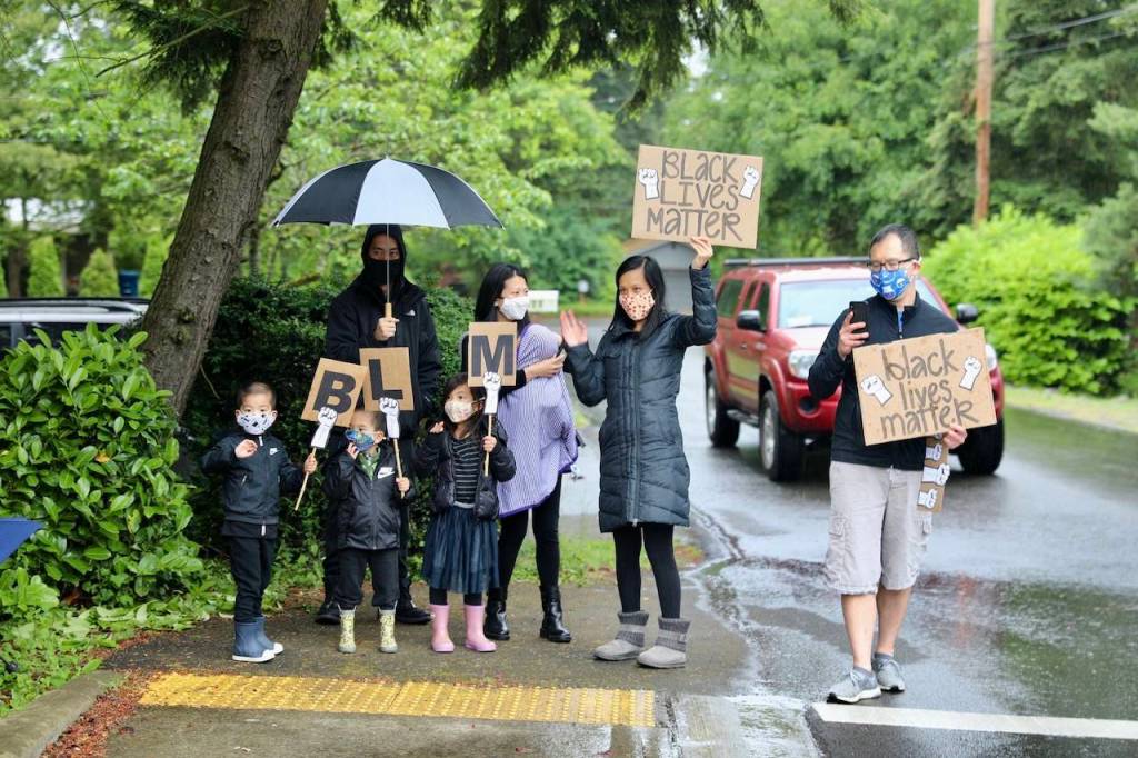 Though not all community members joined in the march, many neighbors stood near their houses to show their support of the protest. Blake Peterson/staff photo
