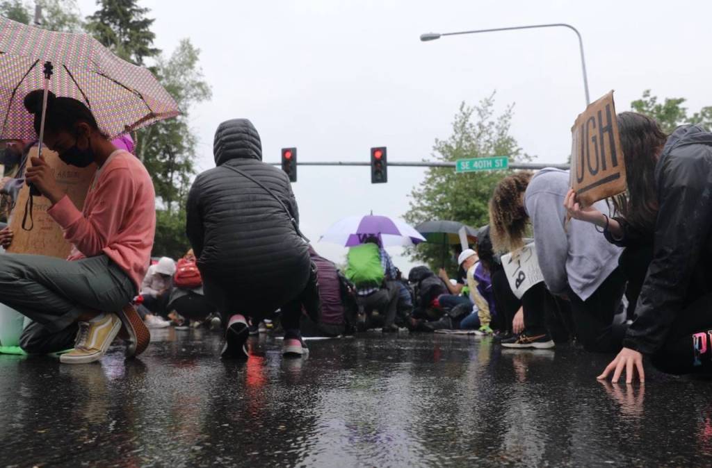 Protestors kneeling in silence at the intersection of Island Crest Way and Southeast 40th Street. The gesture lasted eight minutes and 46 seconds  the amount of time white Minneapolis Police Officer Derek Chauvin knelt on George Floyds neck. Staff photo/Blake Peterson