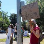 Passing drivers honked and waved in affirmation as protestors held up signs. Blake Peterson/staff photo