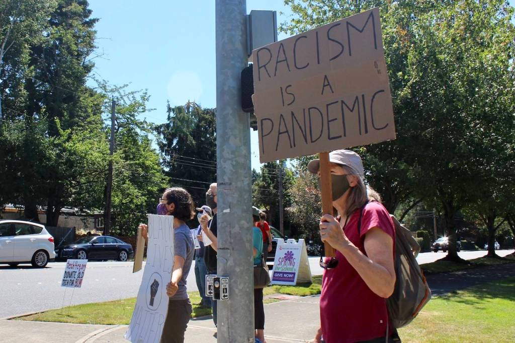 Passing drivers honked and waved in affirmation as protestors held up signs. Blake Peterson/staff photo