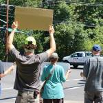 Signs held up at the protest reminded onlookers that Racism is a Pandemic. Blake Peterson/staff photo