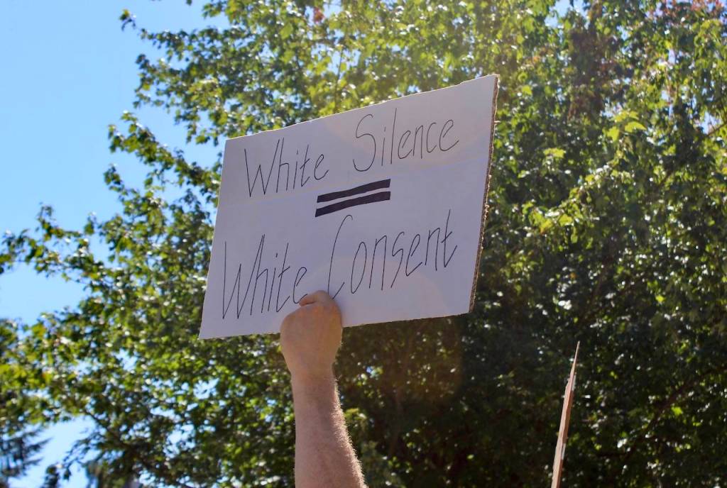 A sign imploring white community members to speak up about racism. Blake Peterson/staff photo