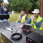 From left to right: Benson Wong, Mercer Island Radio Operators vice chair and radio officer Bob Tykulsker and the organizations chairman emeritus Bill Ellis at the Mercer Island Emergency Preparedness Day in 2019. The radio is being used to contact hams all over the United States and provinces of Canada. They had strung temporary antennas in the trees of Luther Burbank Park. Photo courtesy of the Mercer Island Radio Operators