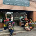 From left to right at Mercer Island Florist, Christina Montilla, business operations and marketing director; Ava Baumgarten, senior shop associate; and Jenna Weischedel, lead designer and shop manager. Black-and-white Havanese Louie is the shop dog. Courtesy photo