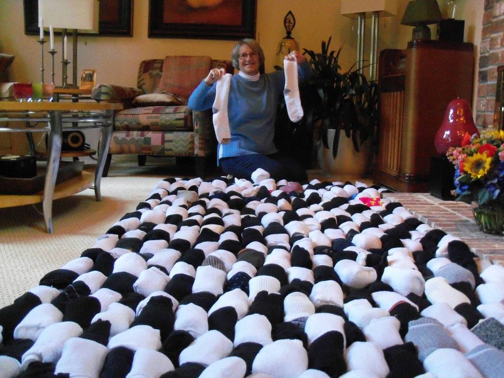 Geri Alhadeff displays the sock donations she collected for the Operation Nightwatch drive. Photo courtesy of Jack Alhadeff