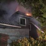 A fire rages at a house in the 3800 block of West Mercer Way. Photo courtesy of the Mercer Island Fire Department