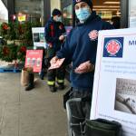 Mercer Island firefighter Jeff Collins (front) and battalion chief Stephen Mair collect donations for QFC gift cards that will be given to the citys Youth and Family Services Food Pantry. They are pictured at QFC north on Nov. 25, and firefighters also collected donations at QFC south on that same day. Andy Nystrom/ staff photo