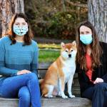 Artist Sophia Scull, left, and author Kathleen Stickney pose with Stickneys dog, Charlie, who is a character in their book First Watch. Photo courtesy of Carrie Scull