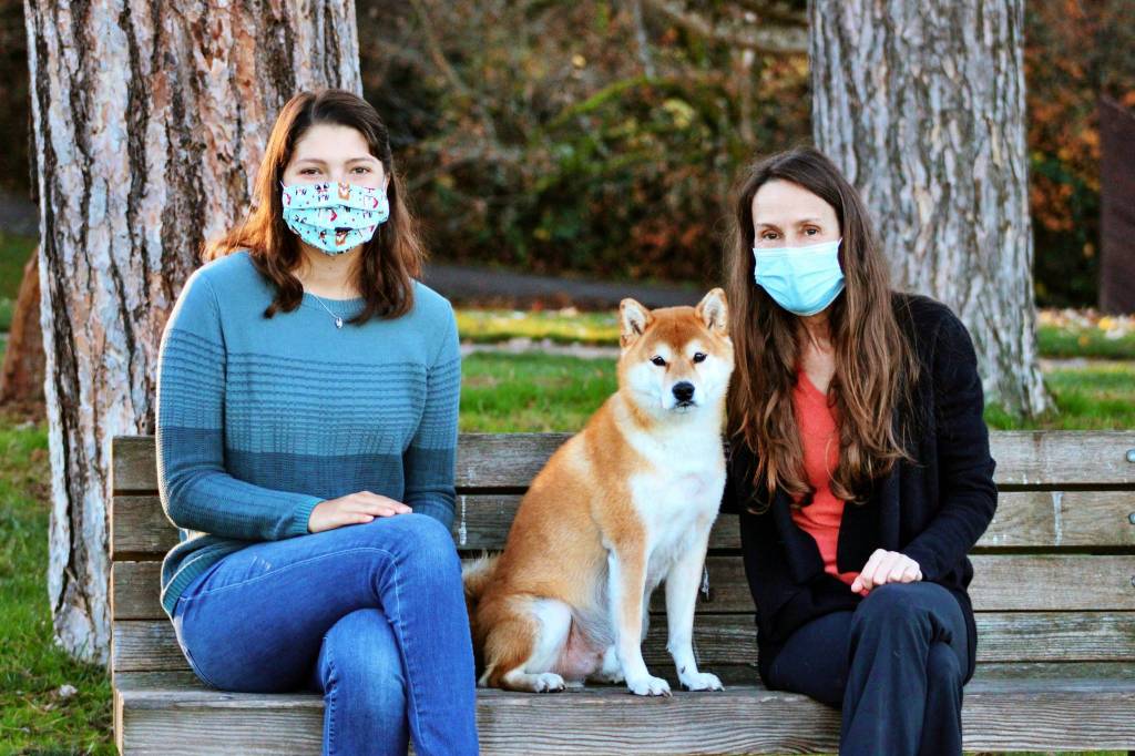 Artist Sophia Scull, left, and author Kathleen Stickney pose with Stickneys dog, Charlie, who is a character in their book First Watch. Photo courtesy of Carrie Scull