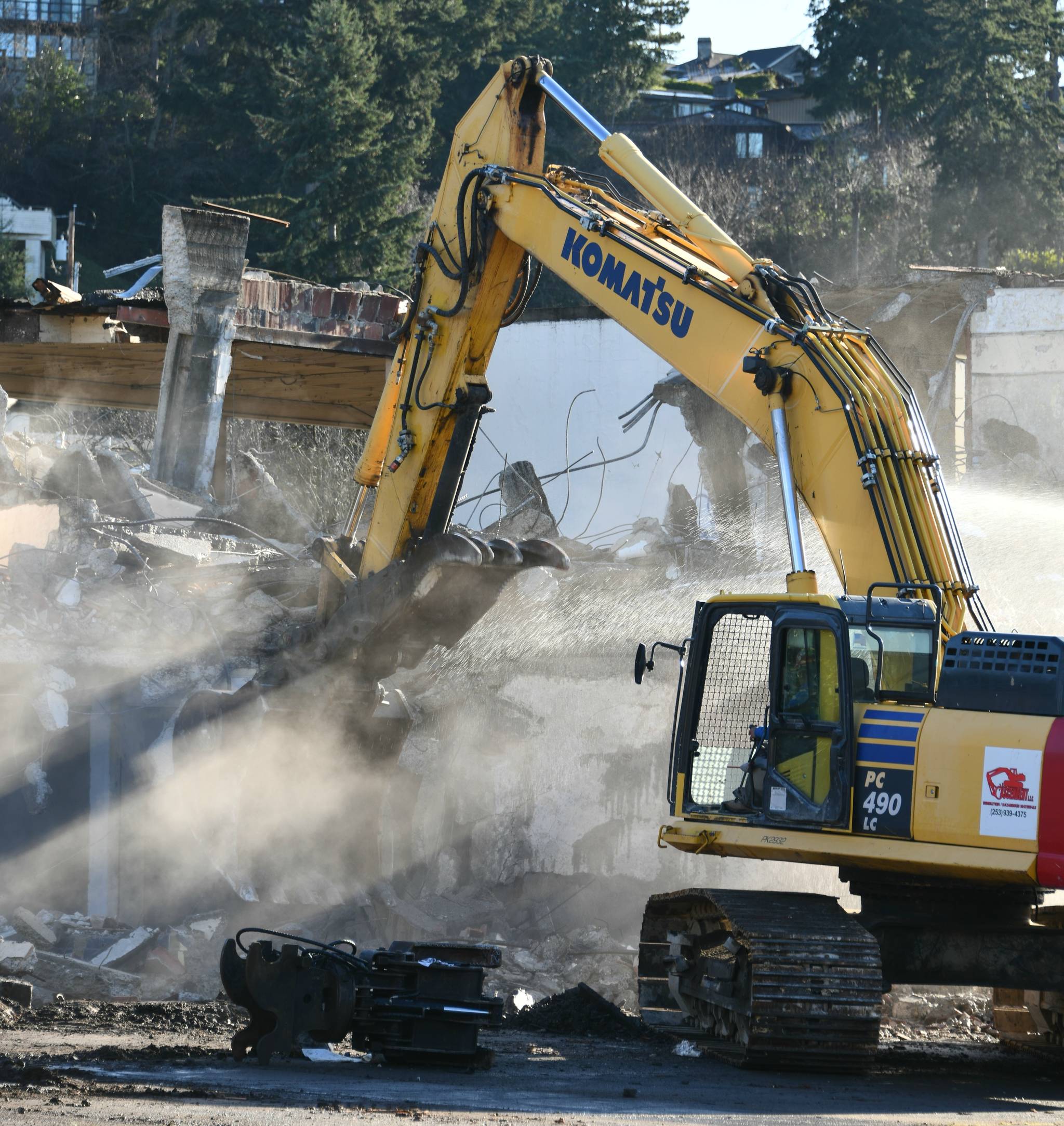 A demolition worker hammers away at the old East Seattle School with a machine on Dec. 28. The city issued a demolition permit for the school  which was built in 1914  on Oct. 28. It is located at 2825 West Mercer Way. The citys decision was informed by the Environmental Impact Statement (EIS), which was completed by EA Engineering, Science and Technology and examined the potential impacts of different alternative actions. An architectural assessment report in the final EIS, notes that, for the most part the buildings have reached the end of their architectural lifespan without extensive, and costly rehabilitation. According to the city website, the property will be subdivided into 14 residential lots. More on the story to come this week. Andy Nystrom/ Reporter