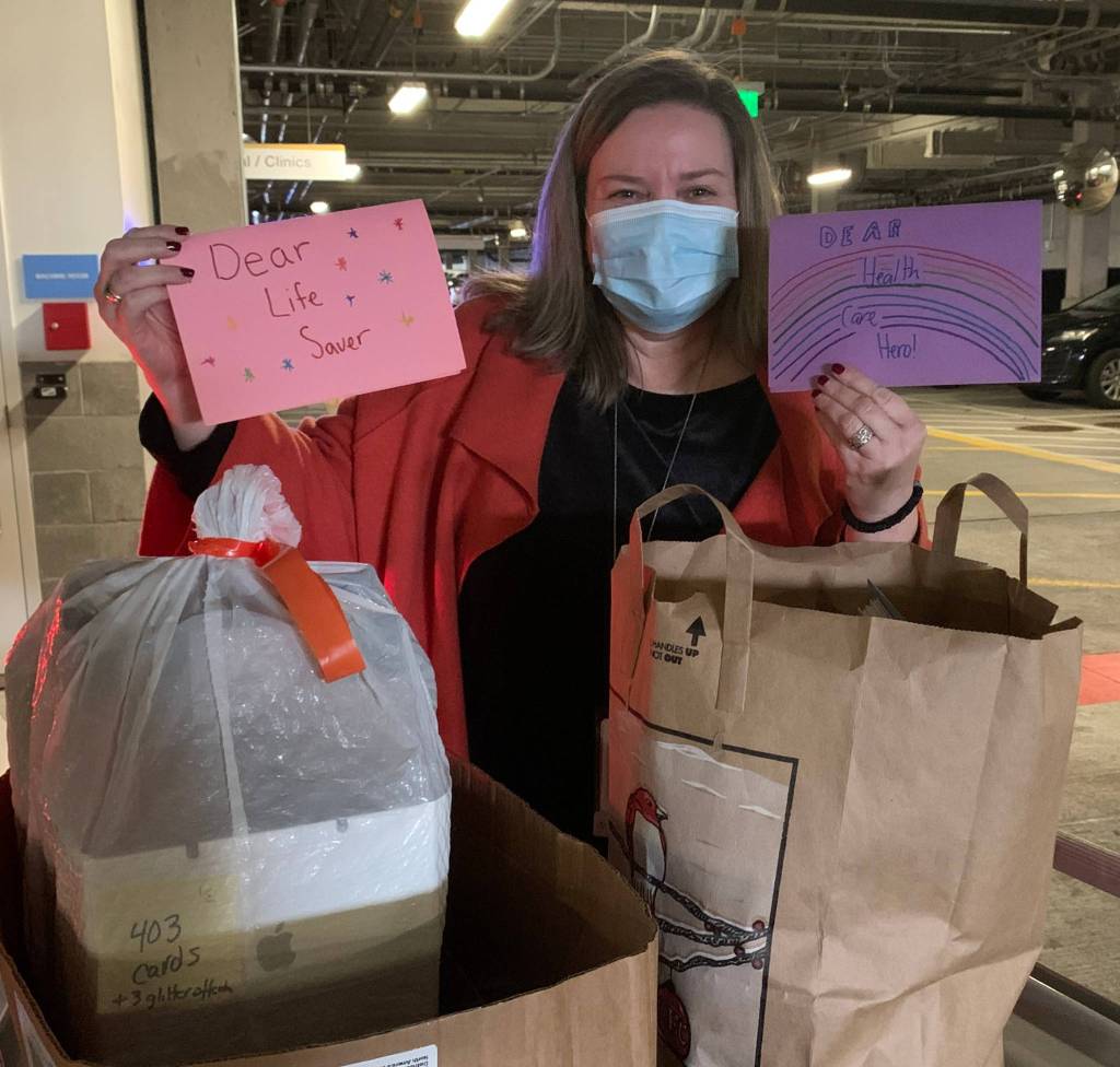 Kelly Huber, interim volunteer services manager at Swedish Medical Centers Issaquah campus, receives a bulk of the 1,600 handmade gratitude cards for healthcare workers created by the National Charity Leagues local Evergreen and Lake Washington chapters. Photo courtesy of Dawn Dunn