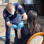 Emergency medical technician Tommy Edwards administers a COVID-19 vaccine dose to a Twilight Adult Family Homes resident on March 8. Photo courtesy of the Mercer Island Fire Department