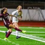 In this 2019 photo, Mercer Islands Emily Yang, left, takes a shot on goal against Liberty. Photo courtesy of Don Borin/ StopActionPhotography