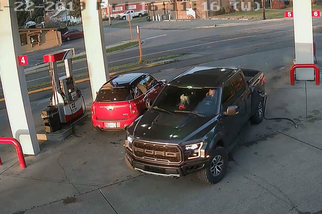 This security footage at the Cenex gas station in Black Diamond shows Anthony Chilcott on his phone before entering, and driving off with, Carl Sanders Ford Raptor and Monkey, his poodle, in the front seat. Image courtesy Cenex gas station