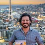 Andrew Meade holds a copy of the Visit Seattle magazine with his photo of the Space Needle on the cover. Photo courtesy of Sophia Ciserella