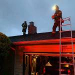 Mercer Island firefighters extinguish a chimney fire on May 3. Photo courtesy of the Mercer Island Fire Department