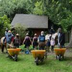 From left, Gary Redman of Redman Construction, Inc., Mercer Island Mayor Benson Wong and Mercer Island City Councilmember Craig Reynolds shovel dirt at the groundbreaking ceremony on May 6 for the restoration of the old Lakeview Schoolhouses teachers cottage, which caught fire in 2018. Andy Nystrom/ staff photo