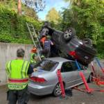 A driver lost control of their vehicle at about 8 a.m. on June 1 and rolled on top of an unoccupied parked vehicle in the 3000 block of Island Crest Way. One person was transported to the hospital for further medical attention, according to the Mercer Island Fire Department Facebook page. Photo courtesy of the Mercer Island Fire Department