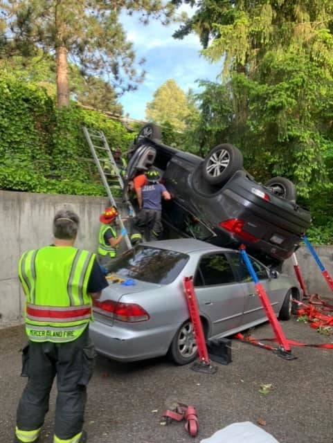 A driver lost control of their vehicle at about 8 a.m. on June 1 and rolled on top of an unoccupied parked vehicle in the 3000 block of Island Crest Way. One person was transported to the hospital for further medical attention, according to the Mercer Island Fire Department Facebook page. Photo courtesy of the Mercer Island Fire Department