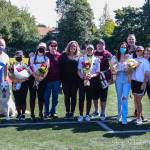 Senior Mercer Island High School fastpitch players, from left to right, Lauren Majewski #21, Chloe Larson #8, Michelle Lyon #16 and Charlise Barokas #7 (not in uniform) gather with their families on senior night on June 4. Photo courtesy of Don Borin/ StopActionPhotography