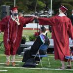 Mercer Island High School graduates fist bump during the class of 2021s ceremony on June 10 at Islander Stadium. Andy Nystrom/ staff photo
