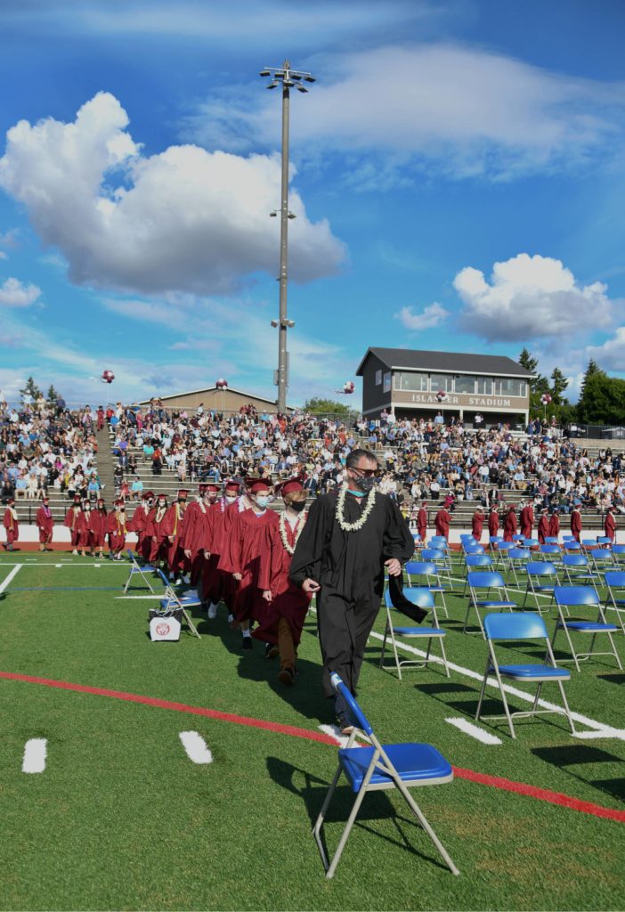 Graduates stroll to their seats. Andy Nystrom/ staff photo