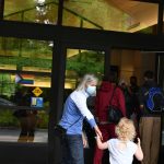 Linda Lisbakken and Berrit Martz, left, prepare to enter the library. There was a round of applause from patrons when the doors opened. Andy Nystrom/ staff photo