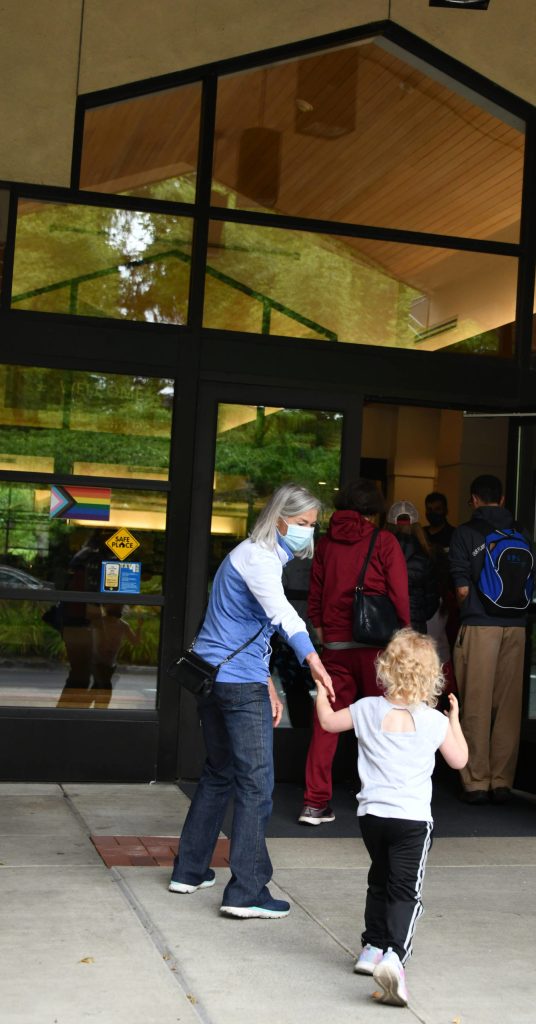 Linda Lisbakken and Berrit Martz, left, prepare to enter the library. There was a round of applause from patrons when the doors opened. Andy Nystrom/ staff photo