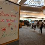 Patrons walk through the library. Andy Nystrom/ staff photo