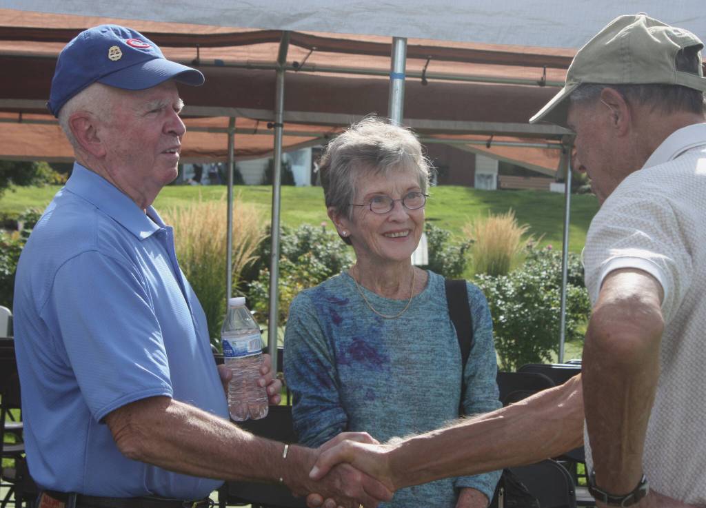 Covenant resident Pete Baird, right, talks with David and Peggy Beamer following the program. Andy Nystrom/ staff photo