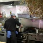 Chef Kyle Bopes working in the kitchen at The Grange. Herbs hang to dry. Photo by Cameron Sheppard/Sound Publishing