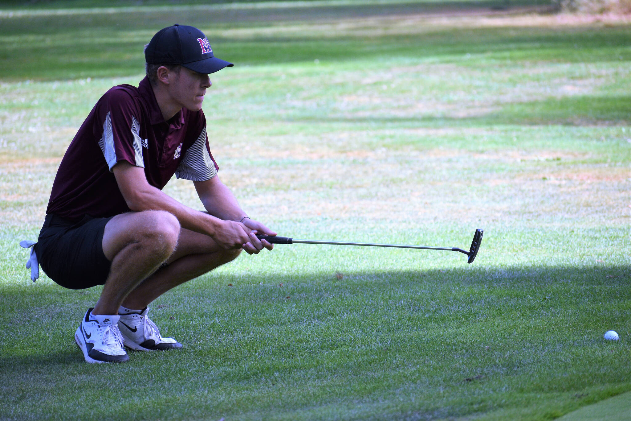 Mercer Island High School senior Ethan Evans lines up a putt. Courtesy photo