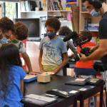 Fifth-grade teacher Damien Majorczyk helps students while being filmed. Photo courtesy of the French American School of Puget Sound