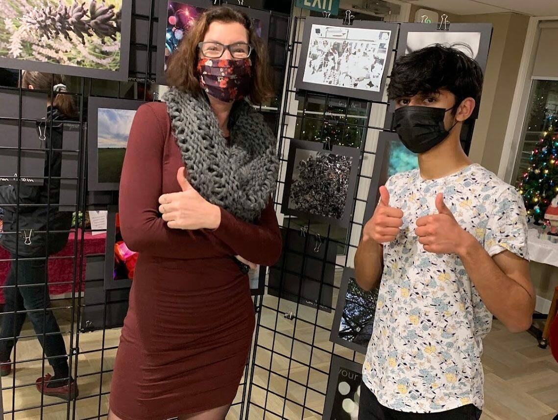 Mercer Island High School photography/advanced placement 2-D teacher Laura Anders and student Mustafa Agha at the schools art show on Dec. 9 at Island House. Courtesy photo