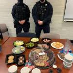 Over the holidays, Mercer Island Police Department officers Chris Smith, left, and Zach Usselman, right, received a food drop-off from community members to show their appreciation for the department. Jan. 9 is National Law Enforcement Appreciation Day. Courtesy photo