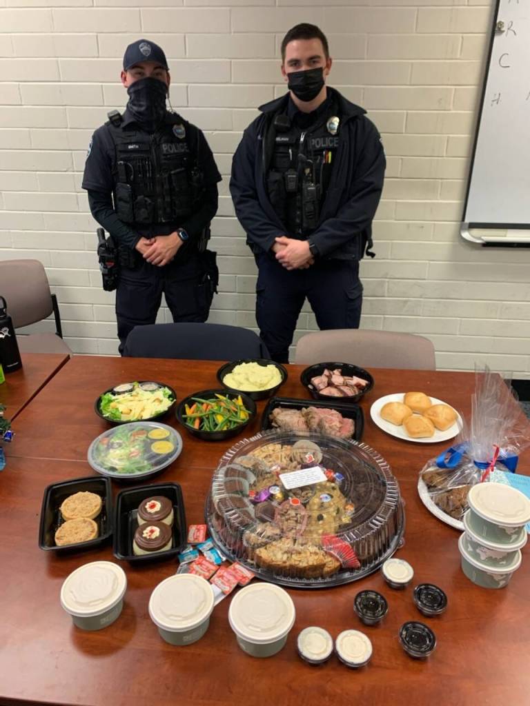 Over the holidays, Mercer Island Police Department officers Chris Smith, left, and Zach Usselman, right, received a food drop-off from community members to show their appreciation for the department. Jan. 9 is National Law Enforcement Appreciation Day. Courtesy photo