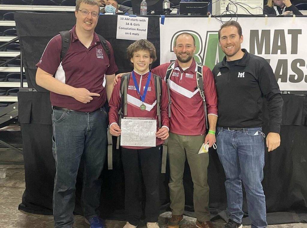 Mercer Island High School freshman Gordon Gibson is pictured at the Mat Classic XXXIII state tournament at the Tacoma Dome with head coach Lee Jahncke and assistants Colton Knebel and Chris Pothoven. Courtesy photo