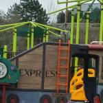 The Mercerdale Park playground train play sculpture and other play equipment sit behind fences until the reopening. Andy Nystrom/ staff photo