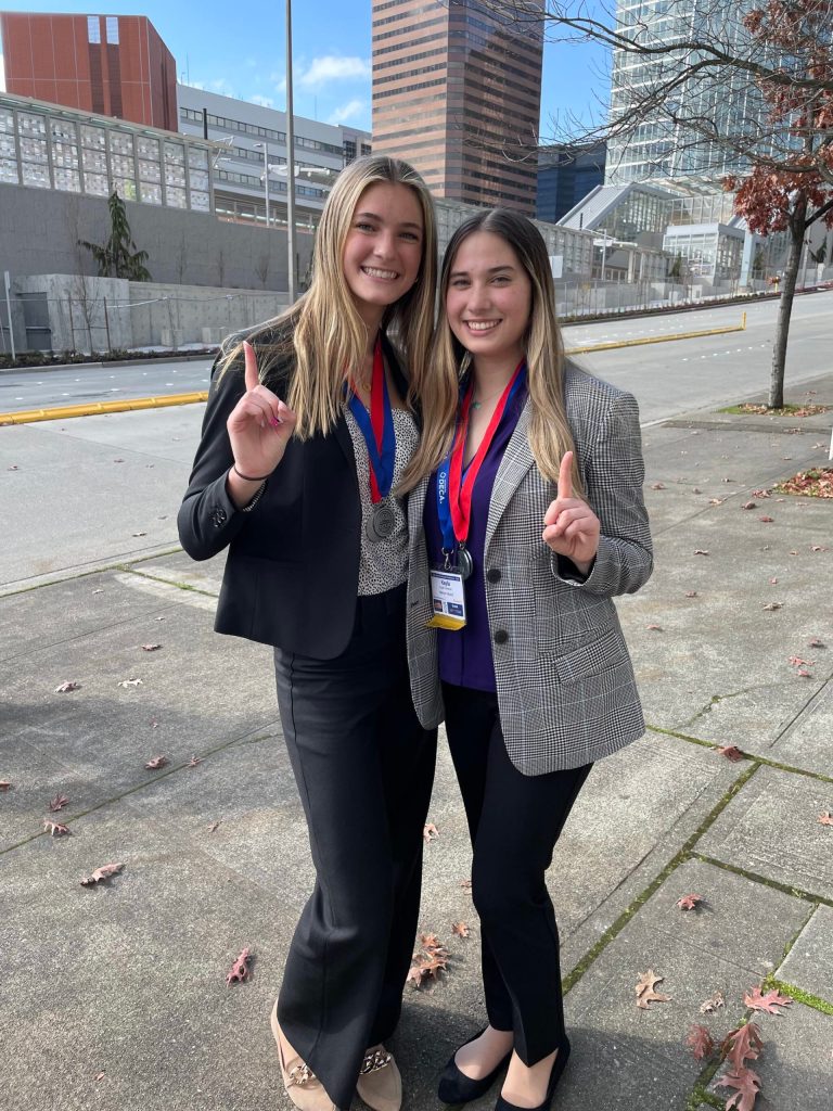 Mercer Island High School seniors Hannah Hobson, left, and Kayla Friedman celebrate their state DECA victory. Courtesy photo