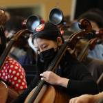 Mercer Island school orchestra members embrace the days theme while performing at the Disney and Dessert Fundraising Event on March 6 in the Mercer Island High School commons. Photo courtesy of Bao-Tran Nguyen