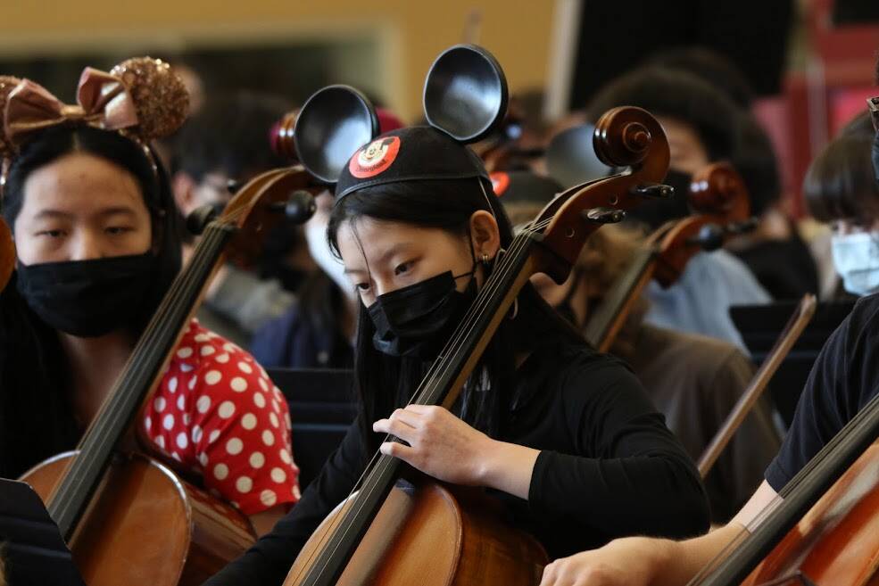 Mercer Island school orchestra members embrace the days theme while performing at the Disney and Dessert Fundraising Event on March 6 in the Mercer Island High School commons. Photo courtesy of Bao-Tran Nguyen