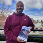 Mercer Island resident Scott A. Weiss displays his new book about legendary Islander boys basketball head coach Ed Pepple. Andy Nystrom/ staff photo
