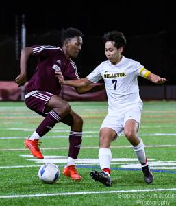 Remington Frederick (#6) keeps the ball away from Alex Cho (#7). Courtesy of Stephanie Ault Justus.