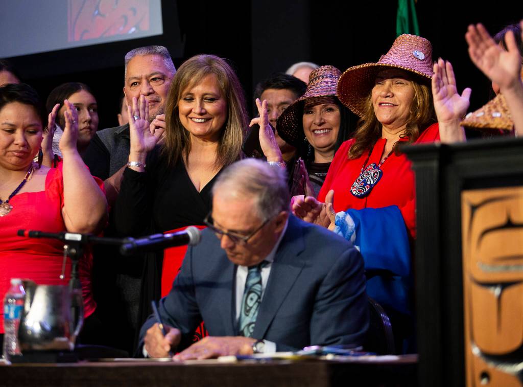 Photo by Olivia Vanni/The Herald
Governor Jay Inslee signs bill HB 1571, a bill relating to protections and services for indigenous persons who are missing, murdered, or survivors of human trafficking, into law at the Tulalip Resort on March 31, 2022.