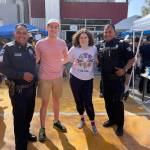 Mercer Island High School juniors Simona Yaroslavsky and Matthew Smith visit with policemen at the Mexico-United States border near San Diego. Courtesy of Rouslana Yaroslavsky