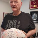 Mercer Island resident Tommy Brasher displays a signed football he received upon his induction into the Arkansas Sports Hall of Fame on April 8. Andy Nystrom/ staff photo