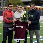 Former Mercer Island High School boys soccer head coach Colin Rigby, left, Jordan Morris, center, and Islanders boys soccer head coach Forrest Marowitz pose for a quick photo on April 23, 2019, at Islander Stadium. Morris was inducted into the Mercer Island High School Athletic Hall of Fame. Photo courtesy of Kim Otte