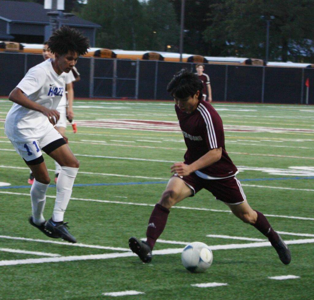 Mercer Islands Nicholas Chou, right, moves the ball past Hazens Hamza Zayan. Andy Nystrom/ staff photo