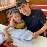 Northwest Yeshiva High School senior Yoel Kintzer reads with a Ukrainian orphan in Neptun, Romania. Courtesy photo